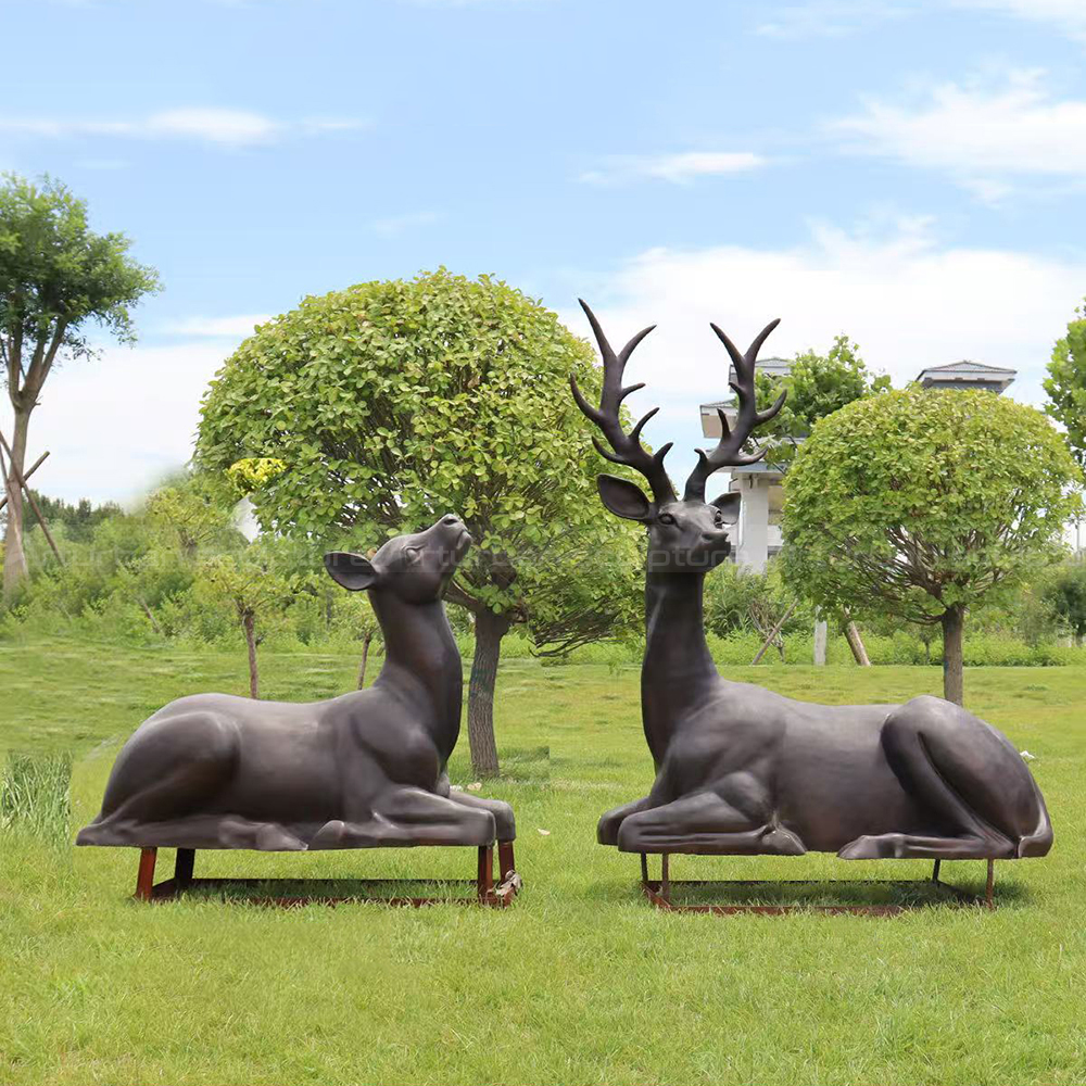 Bronze Stag and Doe Statue resting outdoors