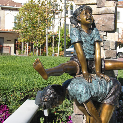 Bronze boy and girl Leap Frog Garden Statue