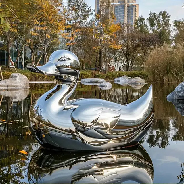 Large metal duck statue in plaza