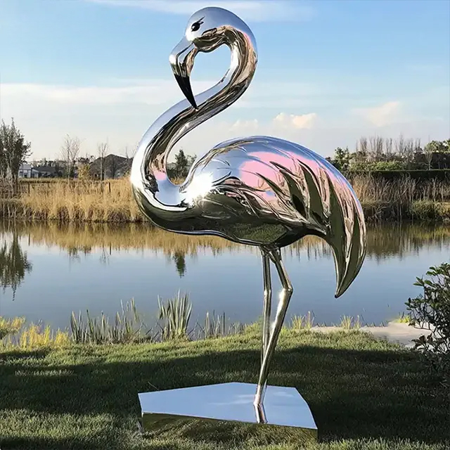 Metal Flamingo Statue standing beside lake