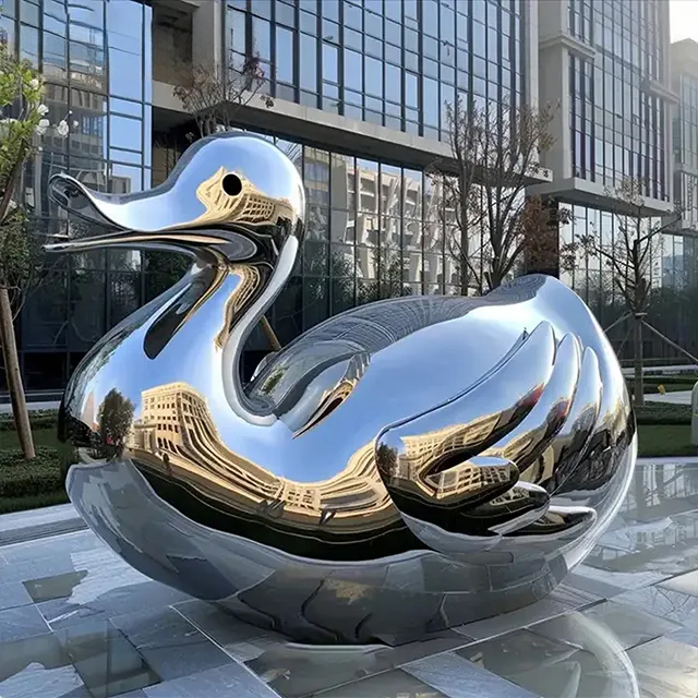 Mirror polished metal duck statue outdoors