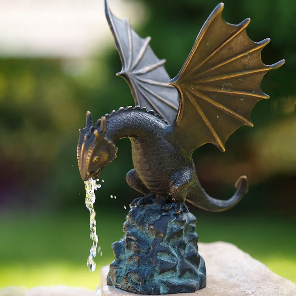 Winged bronze dragon perched above pond