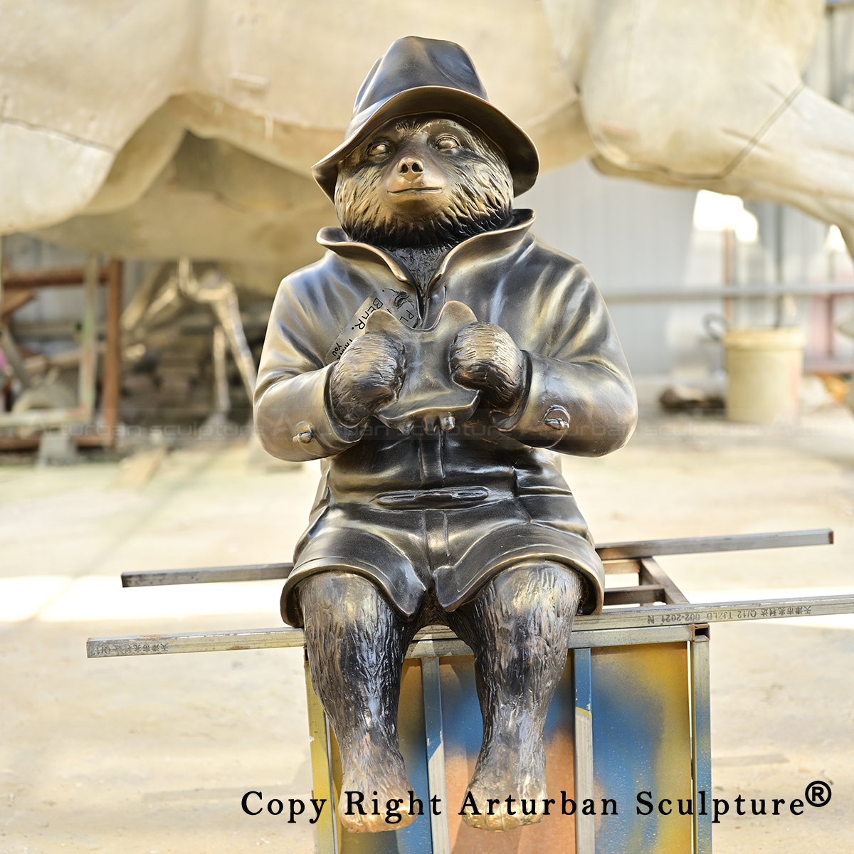 0 Seated bear sculpture holding sandwich