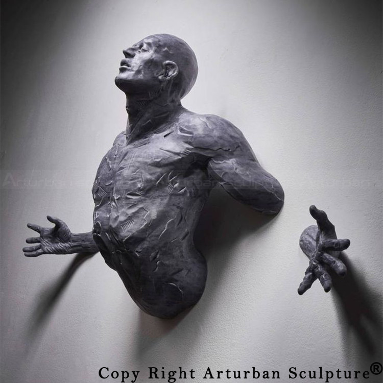 2 man breaking through wall sculpture display