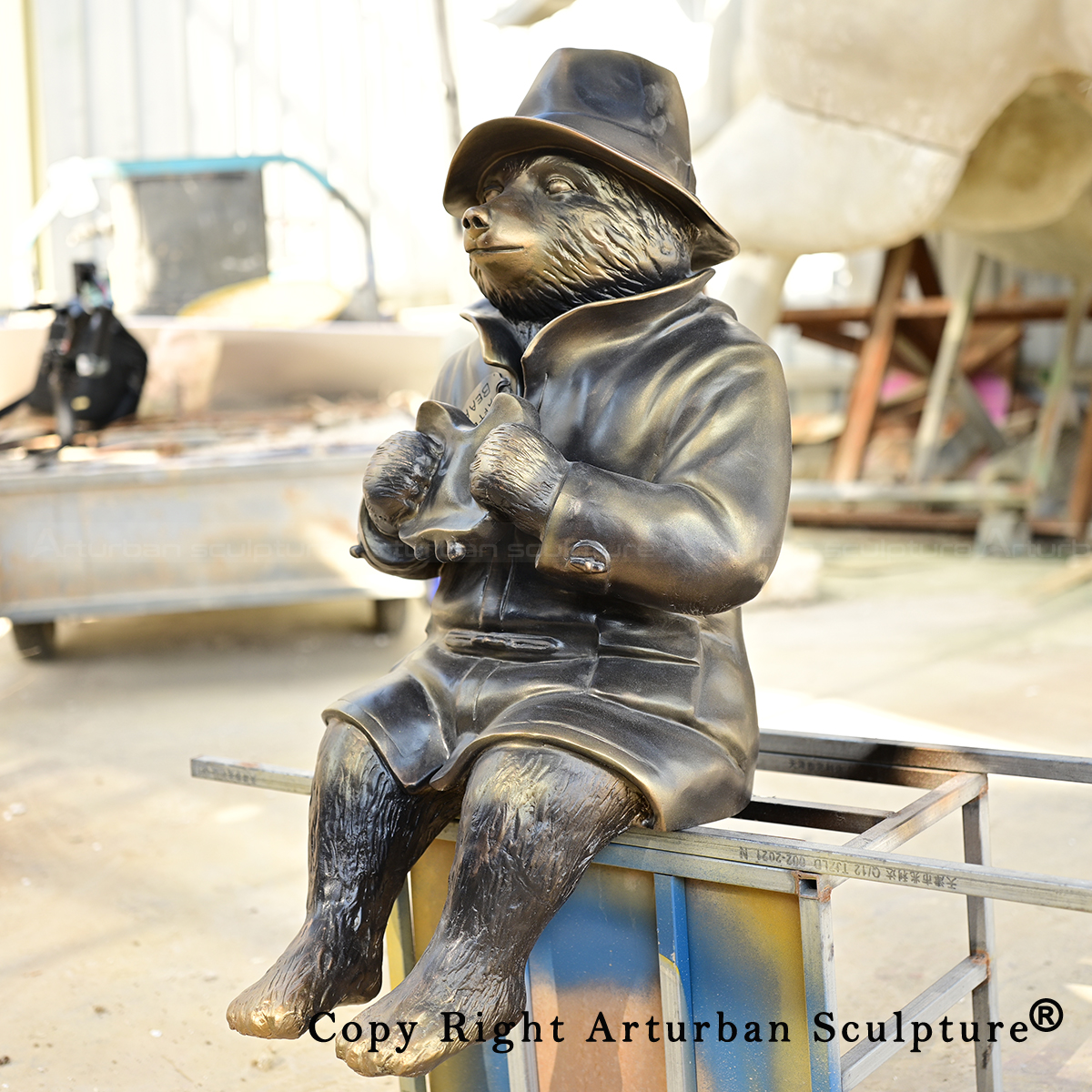3 Paddington Bear Sculpture wearing hat and long coat