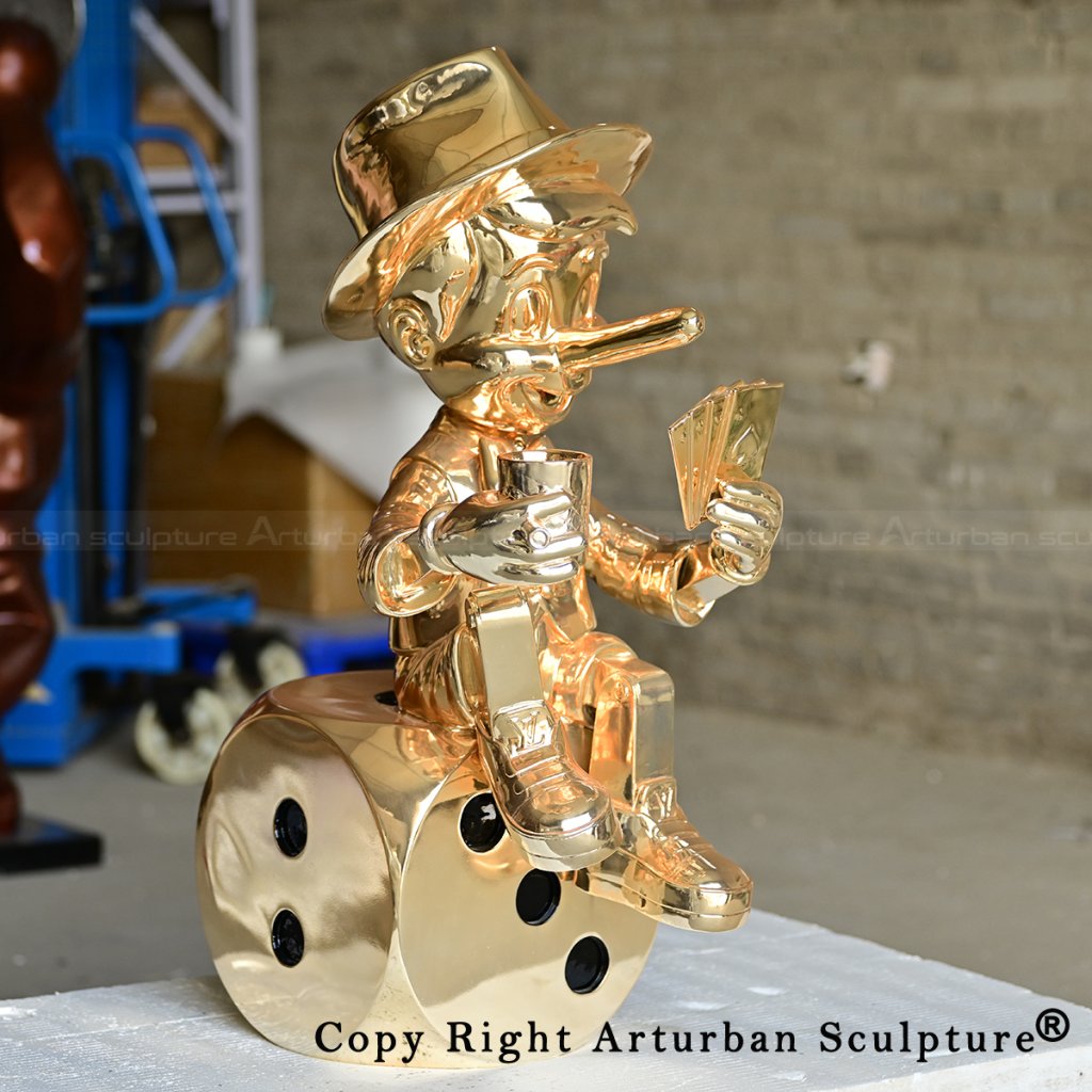 4 brass pinocchio statue holding cards on dice