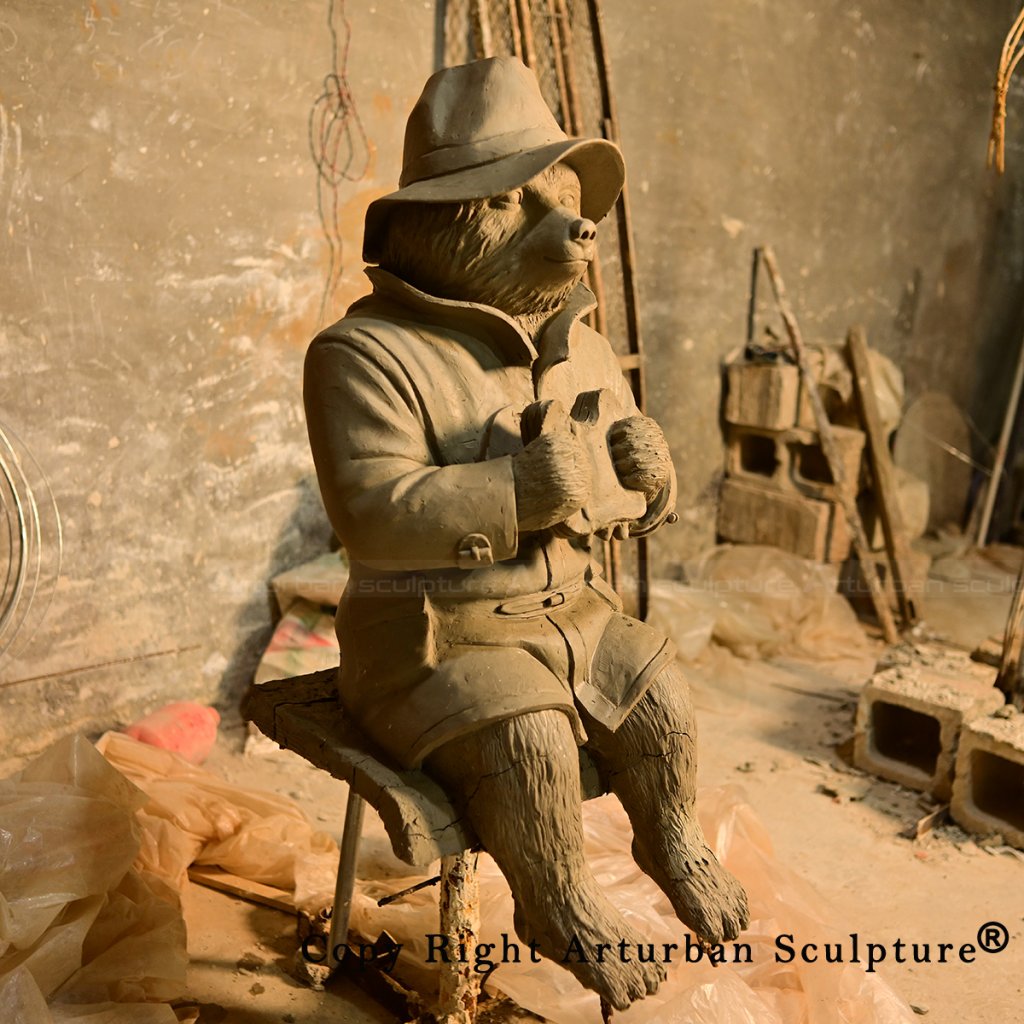 4 Seated clay bear model wearing hat and coat