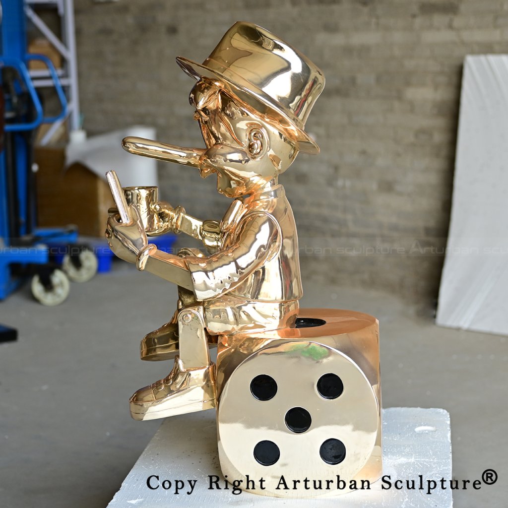 4 Side brass pinocchio statue seated on dice