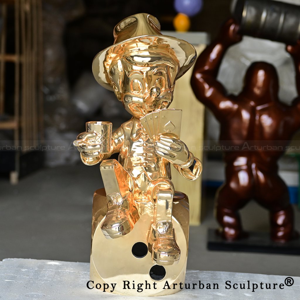 4 golden Pinocchio sculpture on dice base