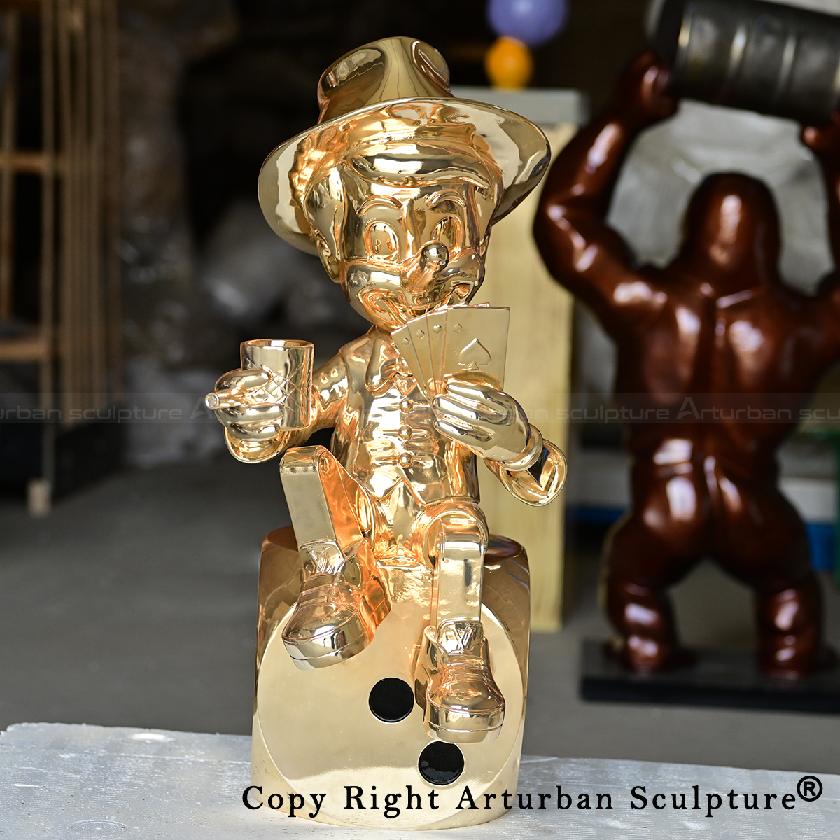 4 golden Pinocchio sculpture on dice base