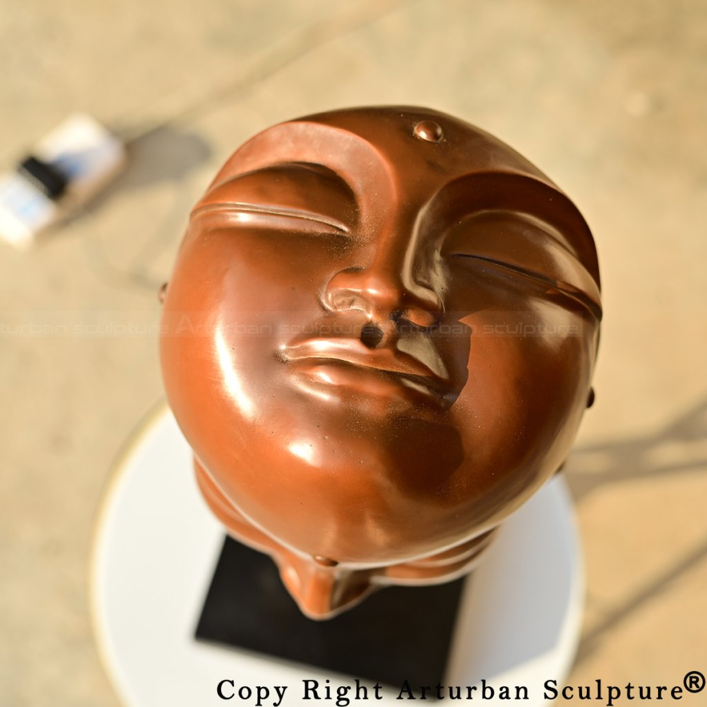 Top view of multi-faced Buddha Face Sculpture