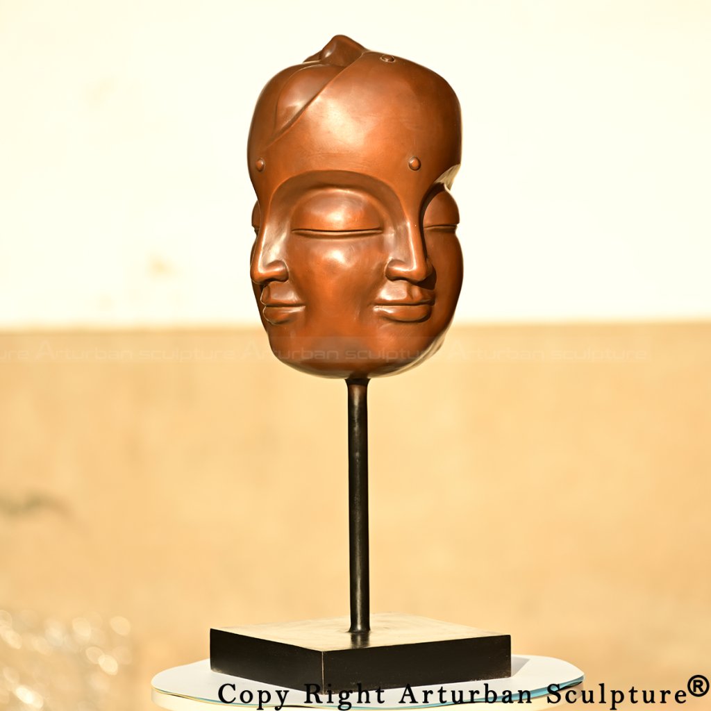 Multi-faced Buddha head on square base