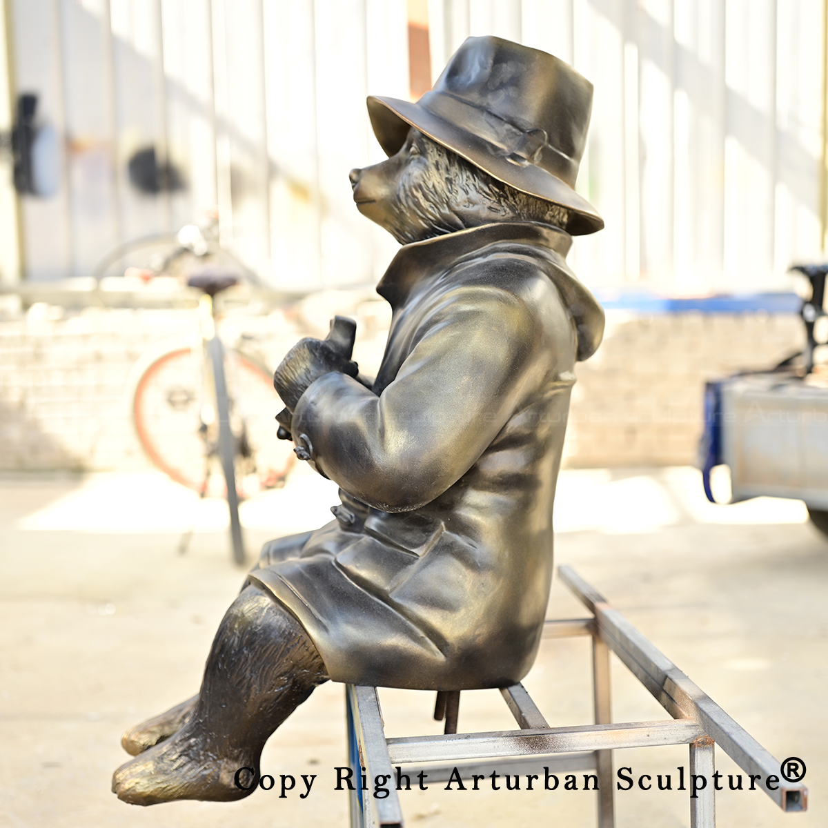 Paddington Bear Garden Statue side view with dangling legs