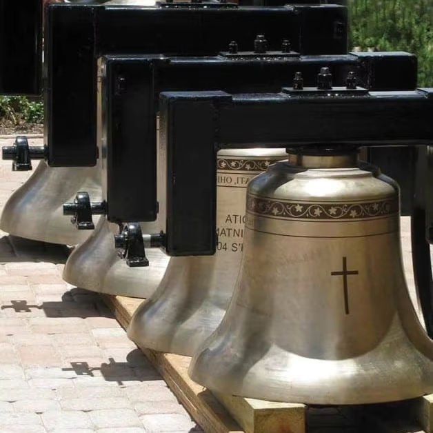 Brass church bell set with cross details