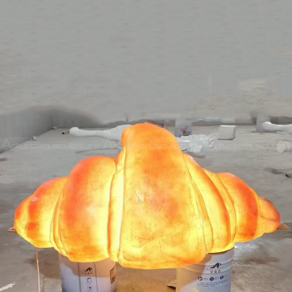 Croissant statue glowing through translucent fiberglass shell