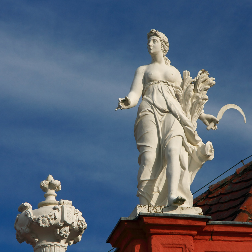 Demeter statue holding sickle and wheat
