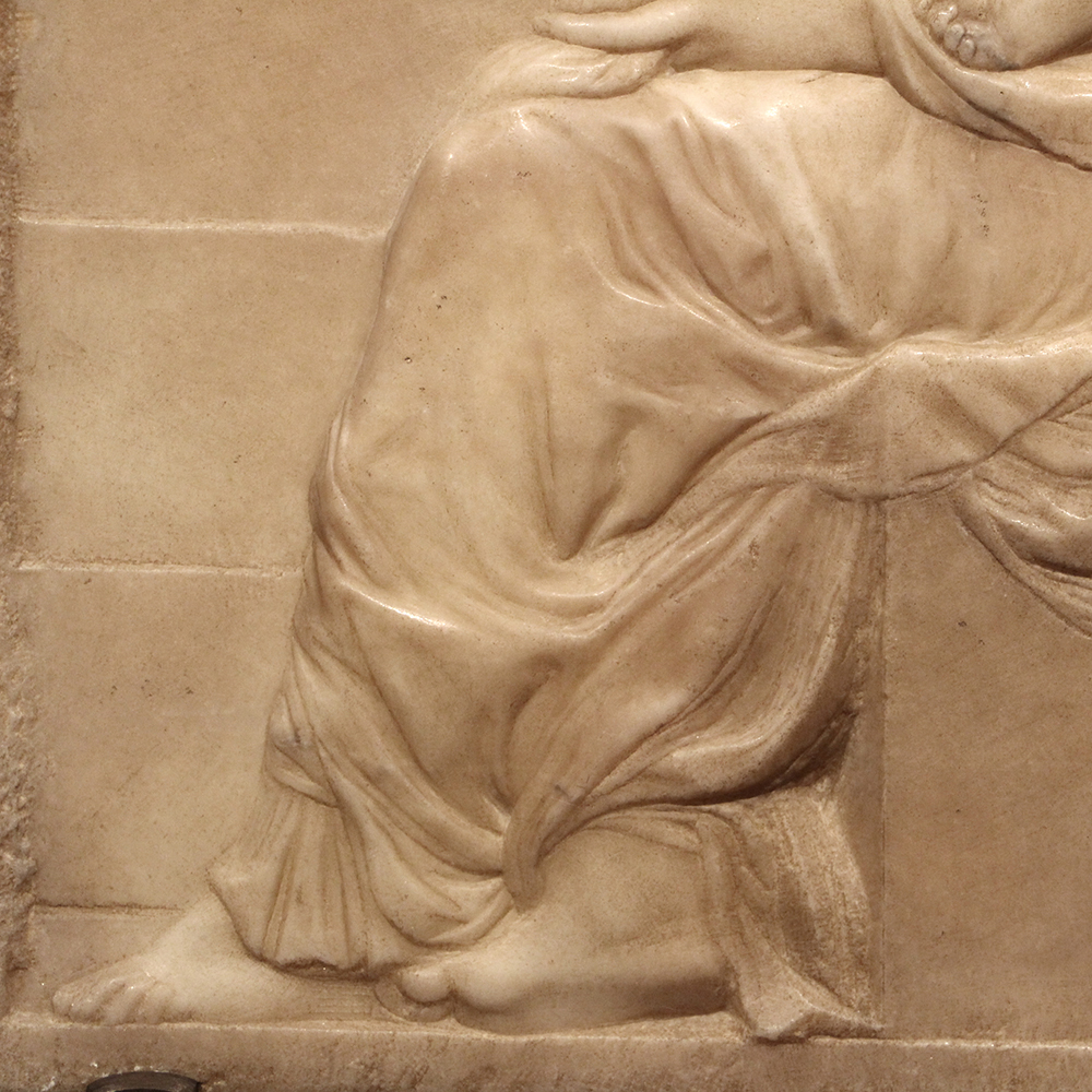 Draped marble figures on staircase relief
