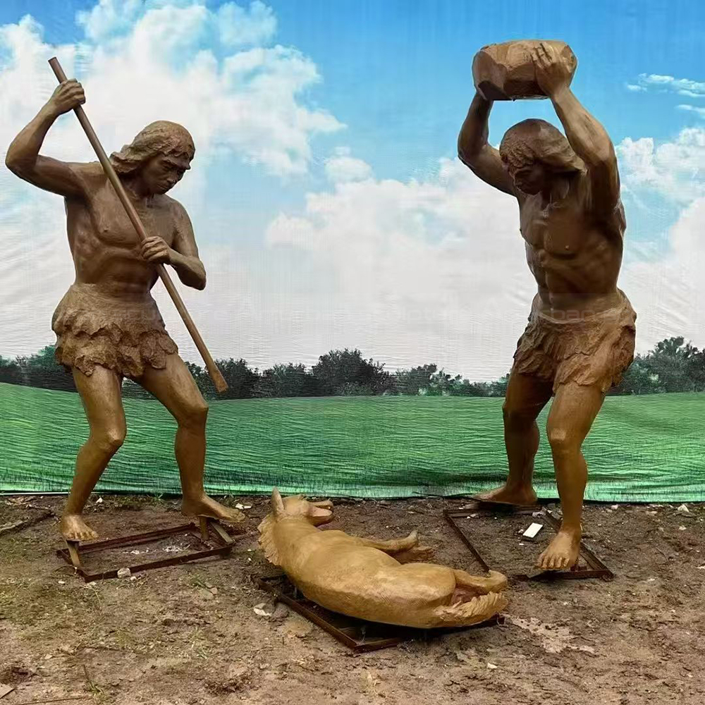 Fiberglass Caveman Sculpture processing prey with stone tools