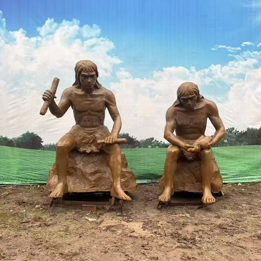 Fiberglass Caveman Sculpture seated during tool making