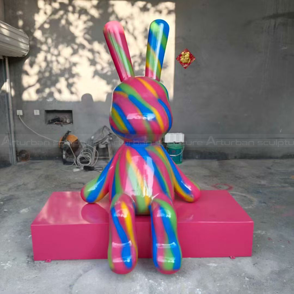 Fiberglass Colorful Rabbit Sculpture on pink pedestal