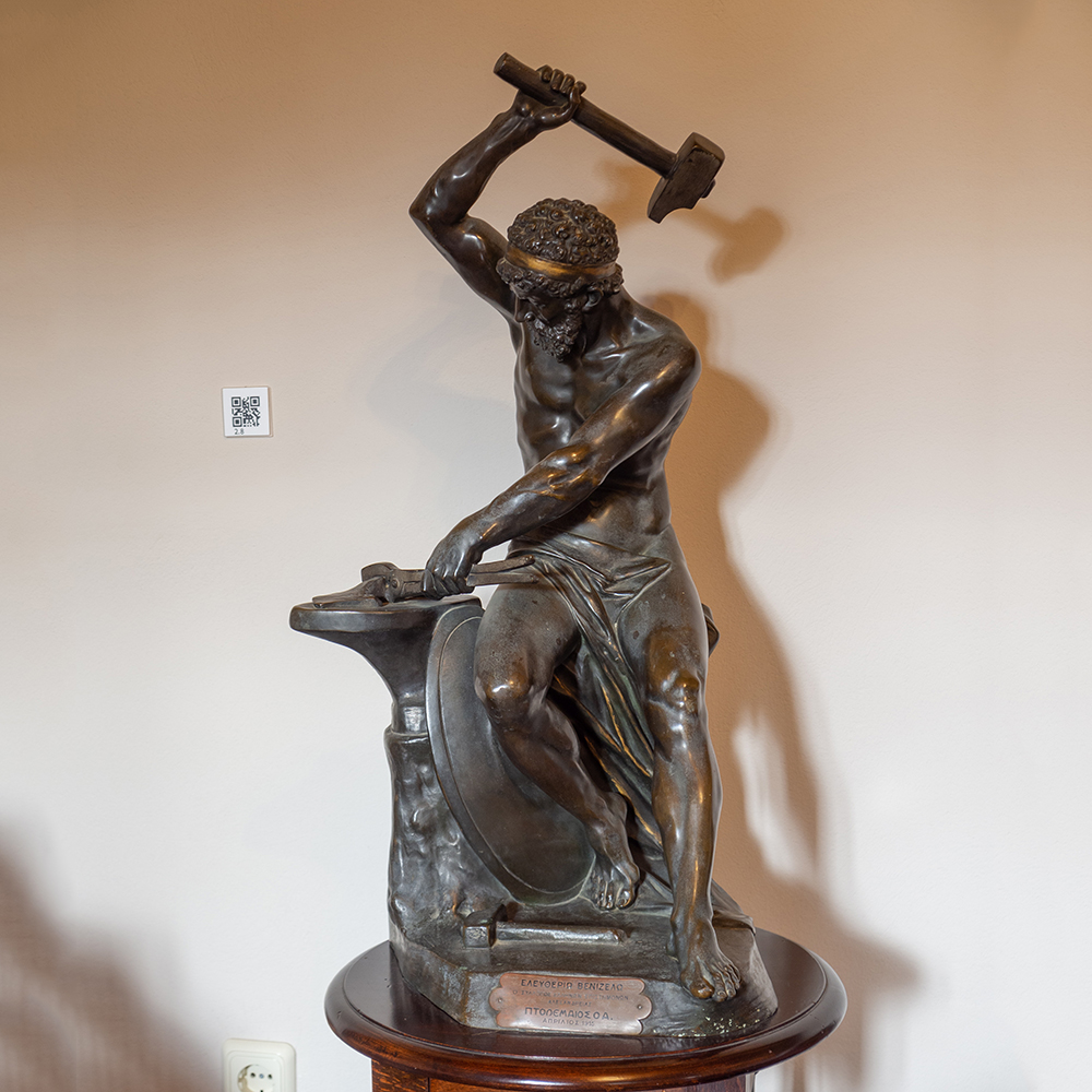 Hephaestus bronze statue forging at anvil