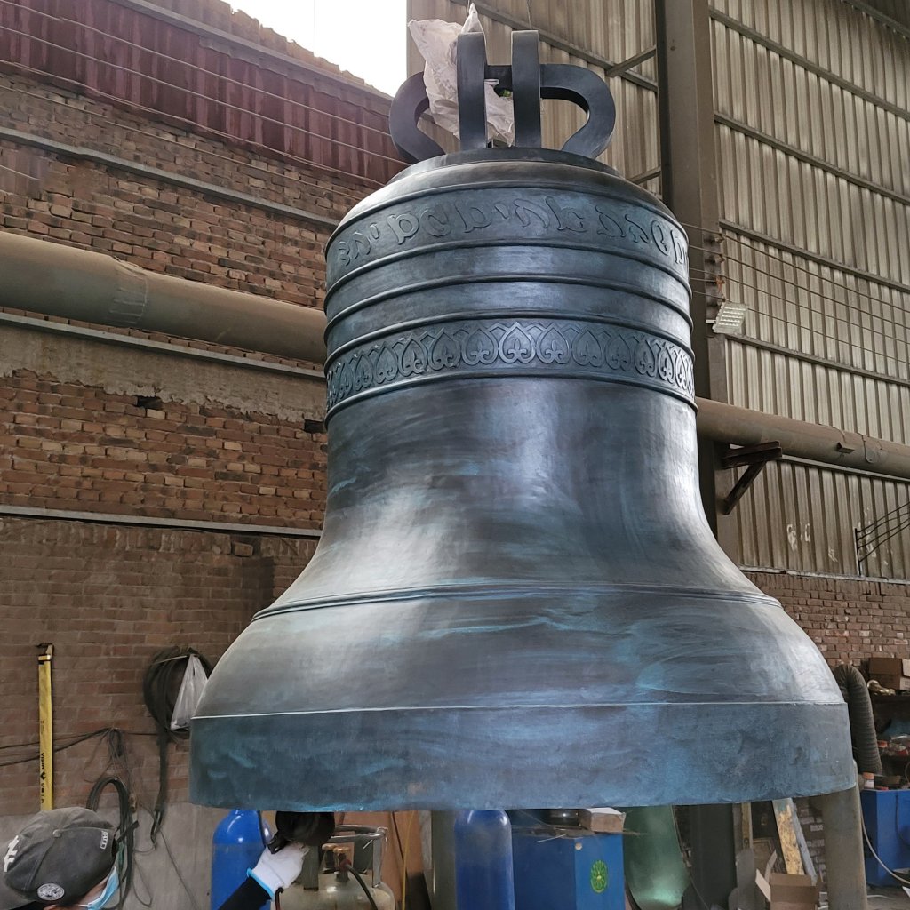 Large bronze temple bell for sale in workshop