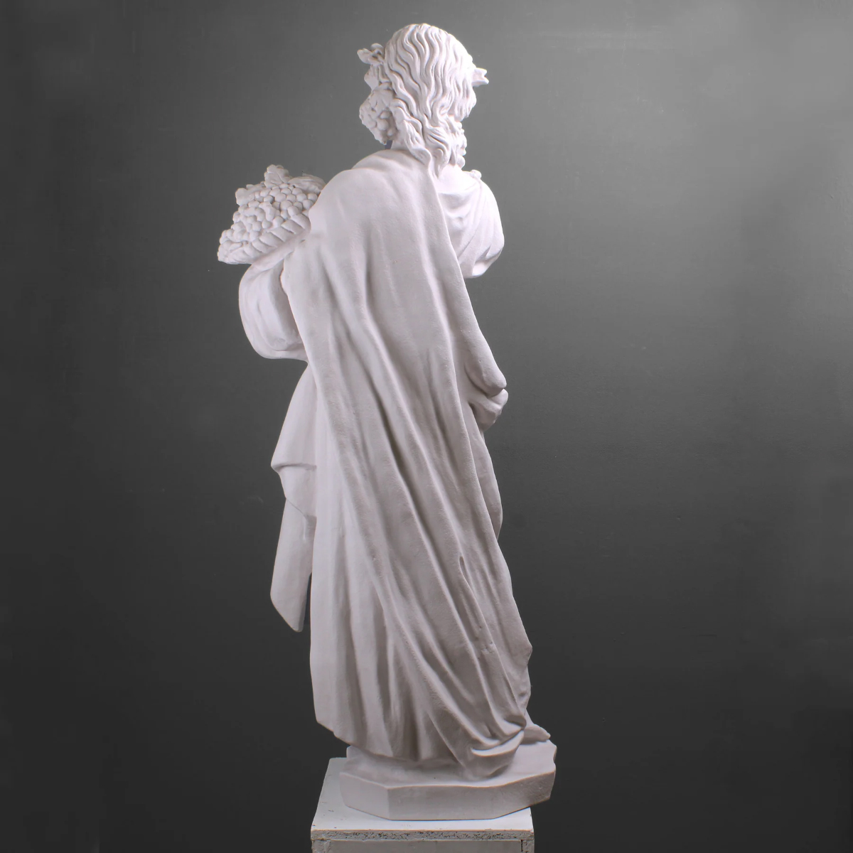 Marble goddess holding harvest grapes