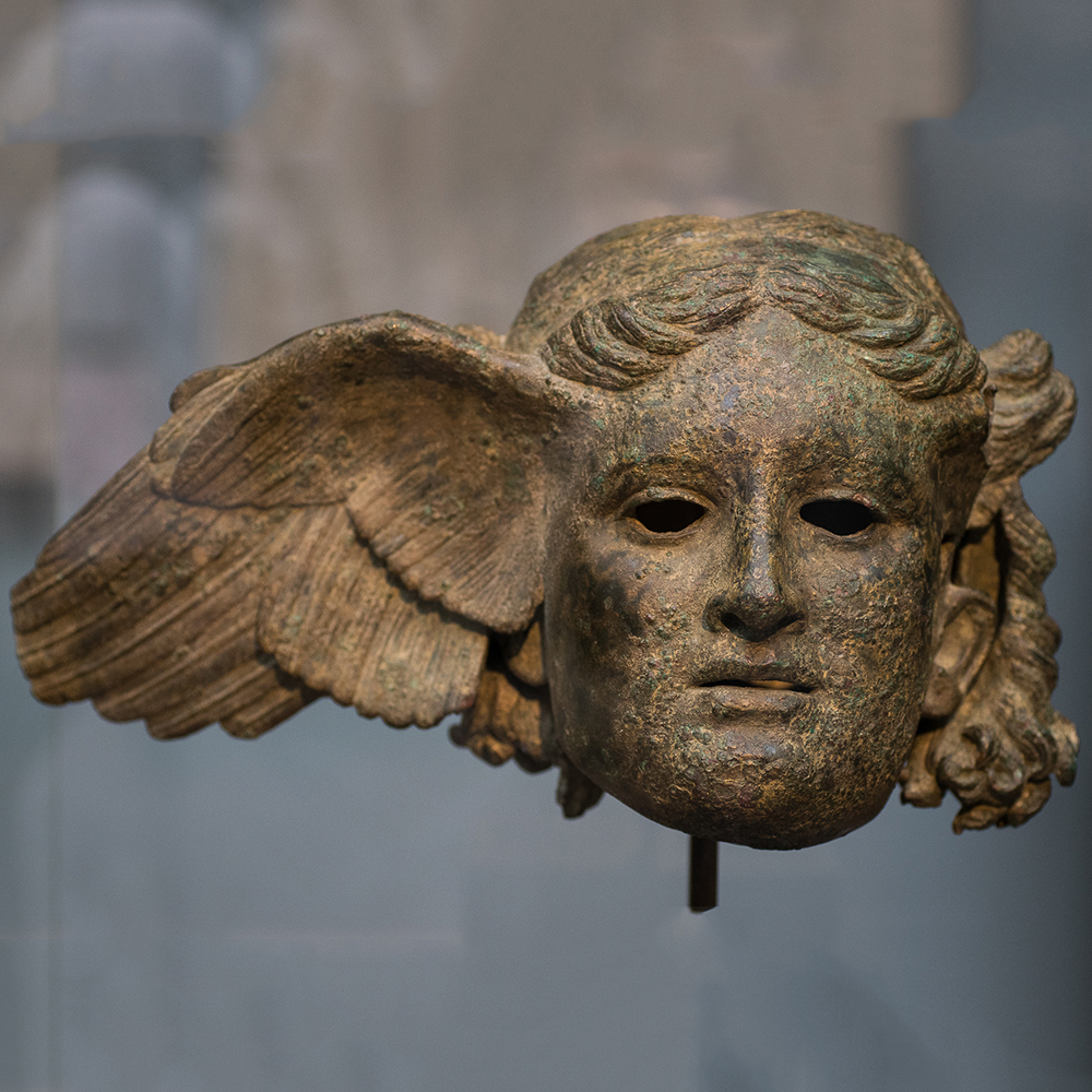 Winged bronze head of Hypnos