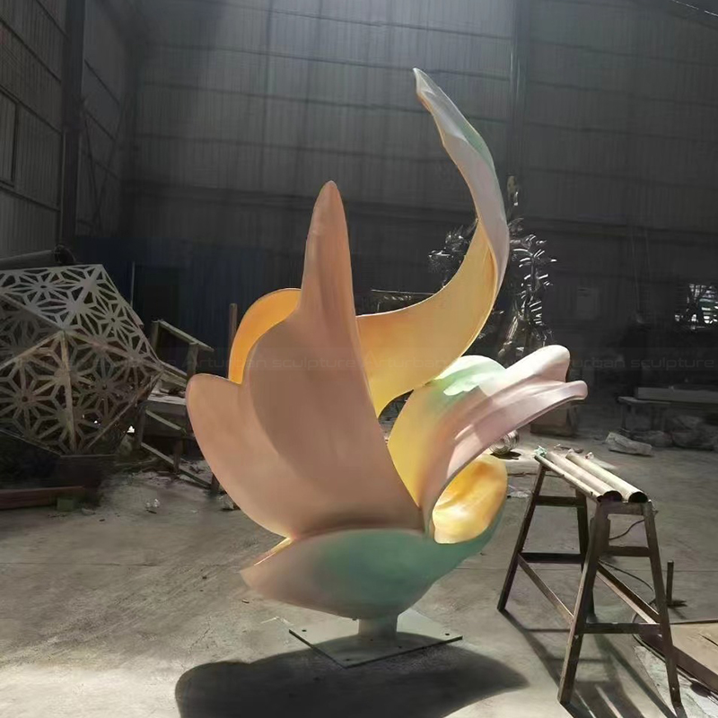 Abstract flower statue featuring layered stainless steel petals