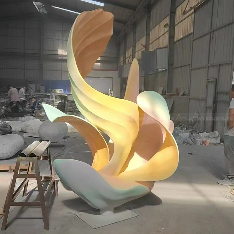 Abstract flower statue with curved stainless steel petals