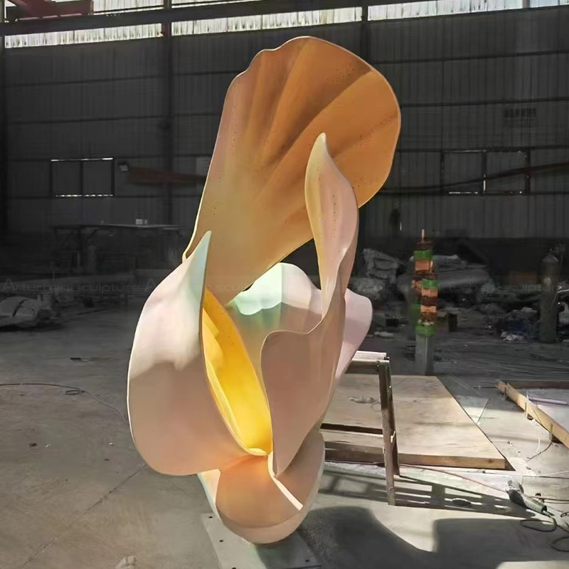 Abstract flower statue with sweeping stainless steel forms