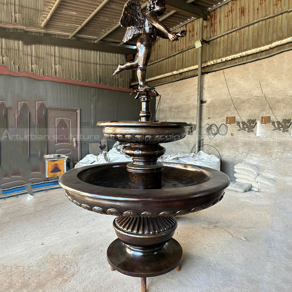 Bronze Cherub Fountain topped by winged child