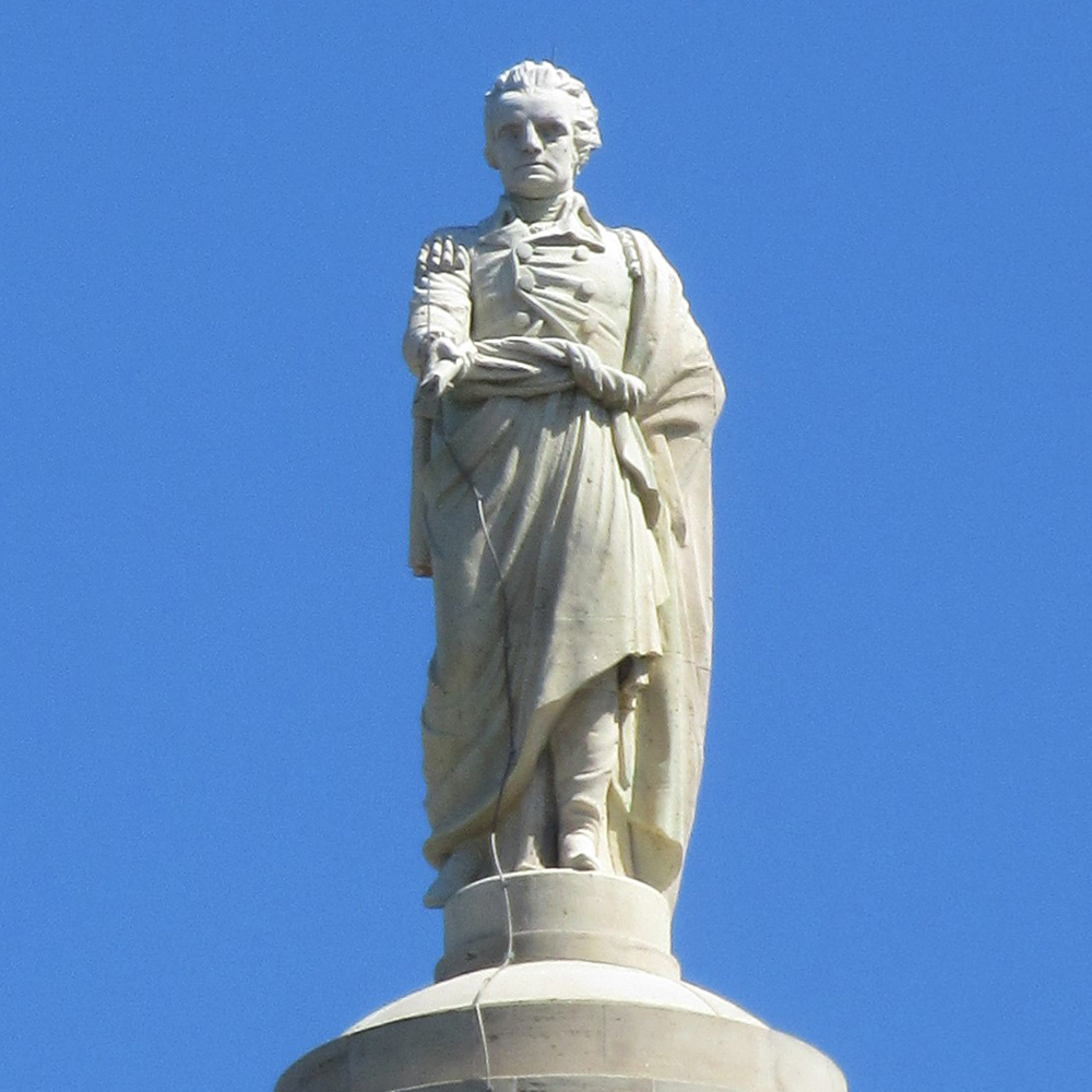 George Washington statue holding military commission scroll
