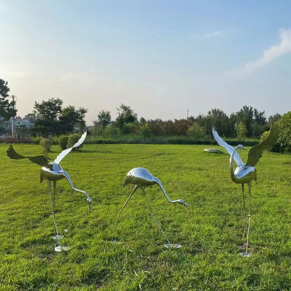 Metal Crane Yard Art grazing on grass