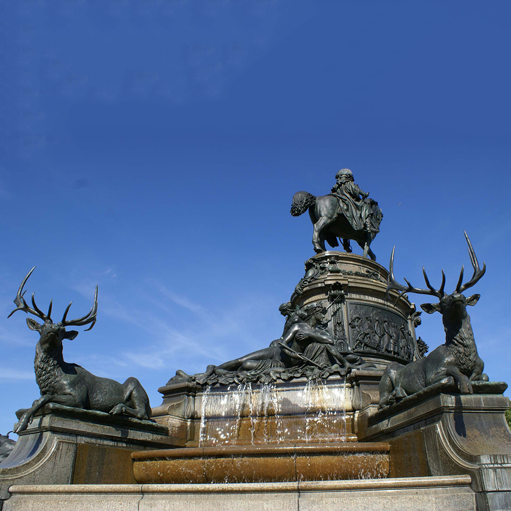 Monument base with bronze elk and fountain