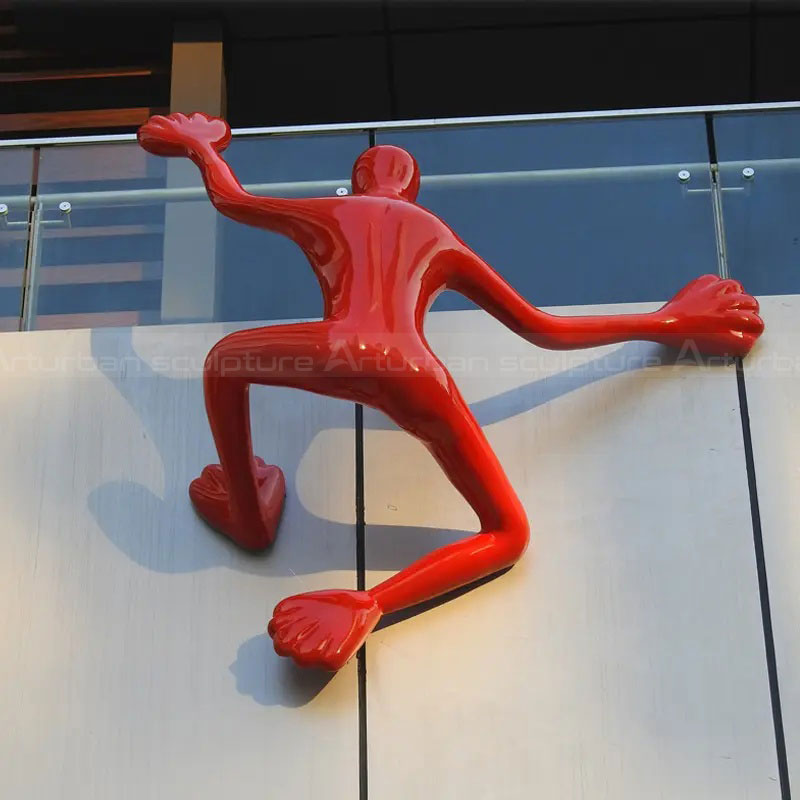 Red fiberglass Climbing Man Art Sculpture closeup