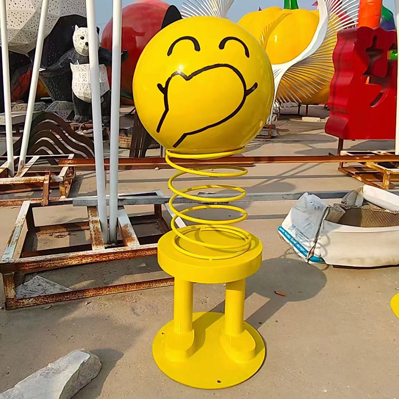 Smiley Face Statue covering mouth playfully