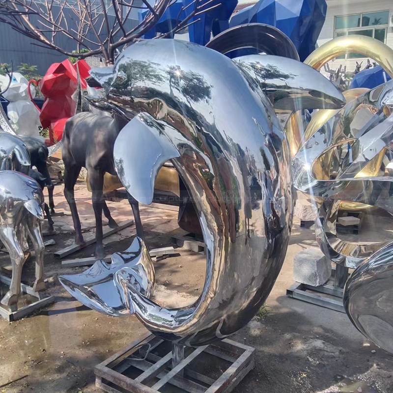 Stainless steel dolphin sculpture with curved body