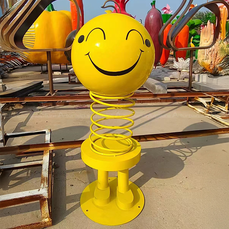 Stainless steel spring statue with smiling face