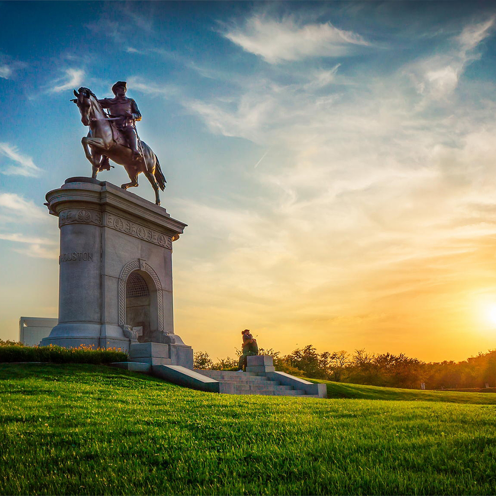 Bronze equestrian monument at Hermann Park sunset