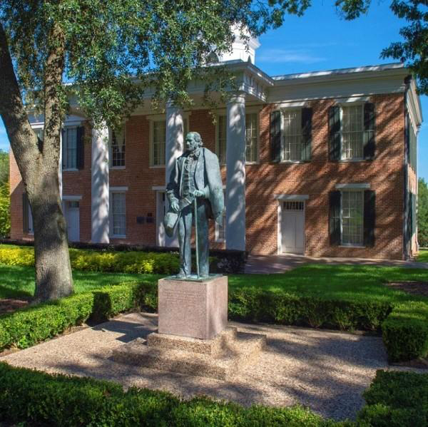 Historic bronze statue outside university building