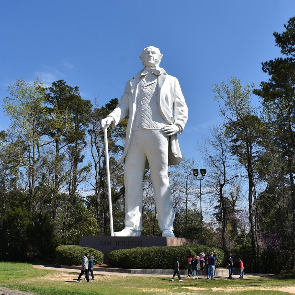 Sam Houston statue with visitors in Huntsville